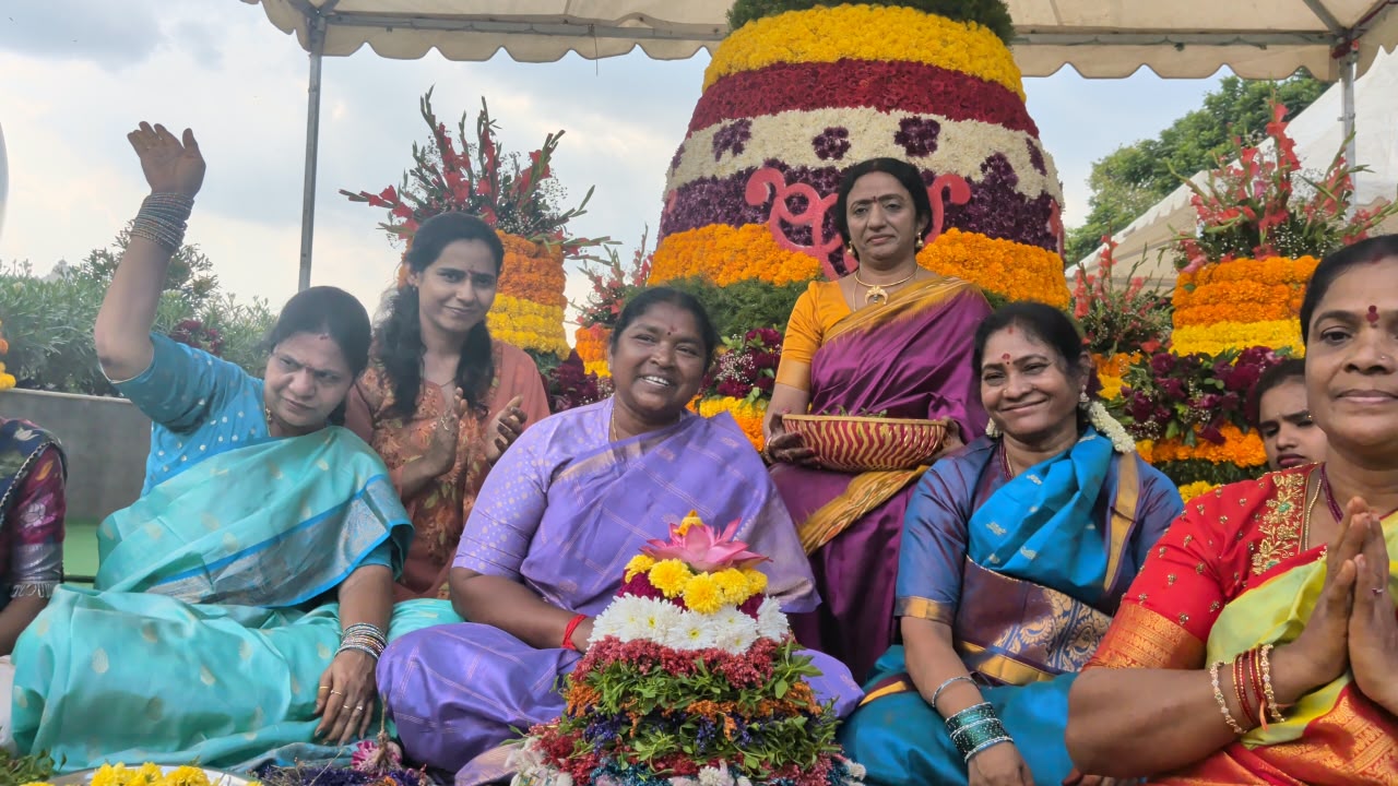 Minister Seethakka Arranges Bathukamma Flowers Alongside Women